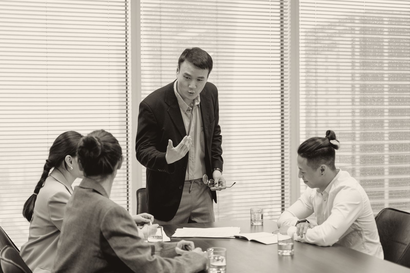 A sales manager in a suit pressing his point while his team sits back, listening and unconvinced
