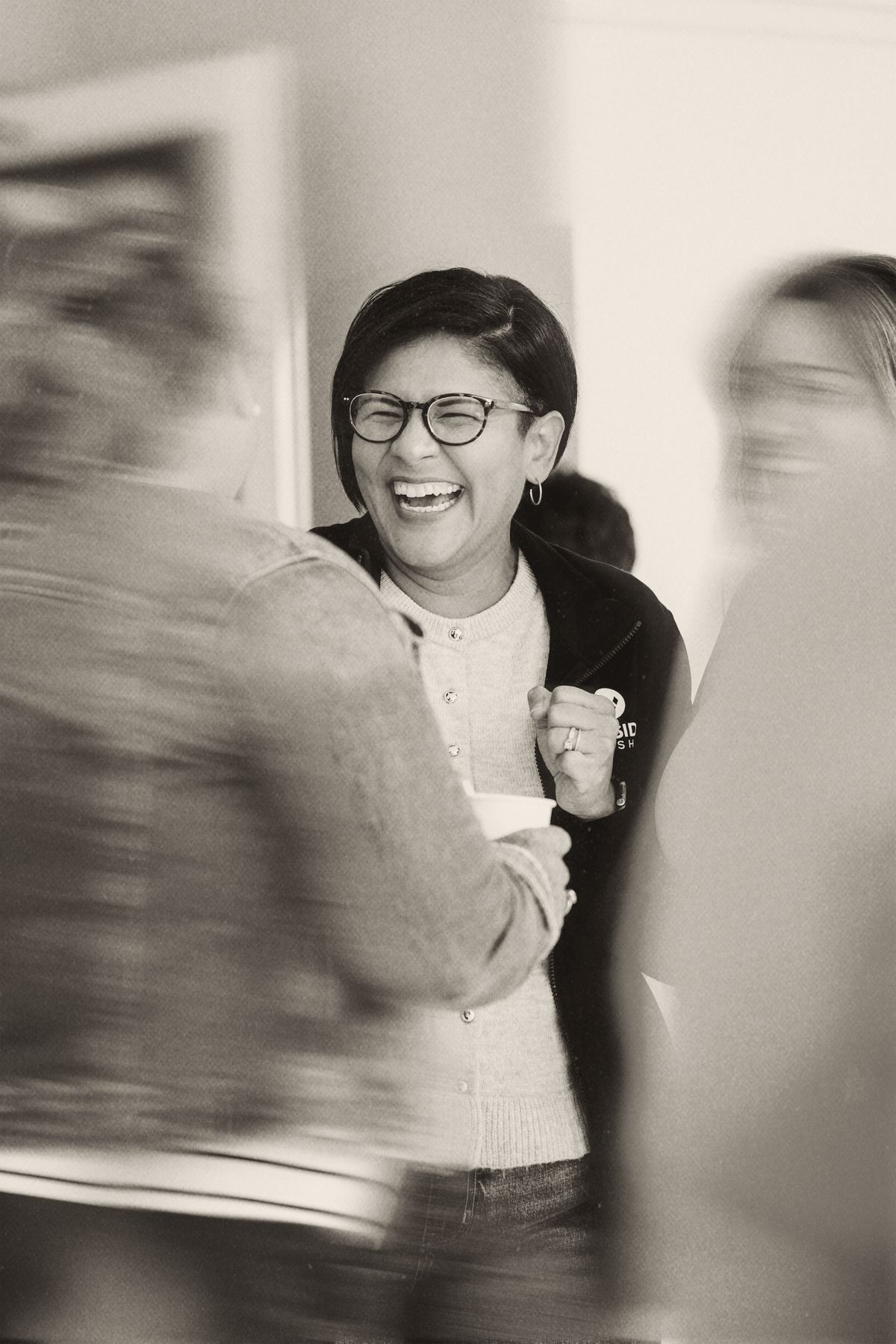 A leader laughing with others in a Business Enneagram community gathering