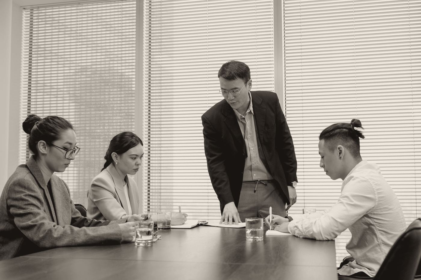 A manager talks at the team while they look down and away